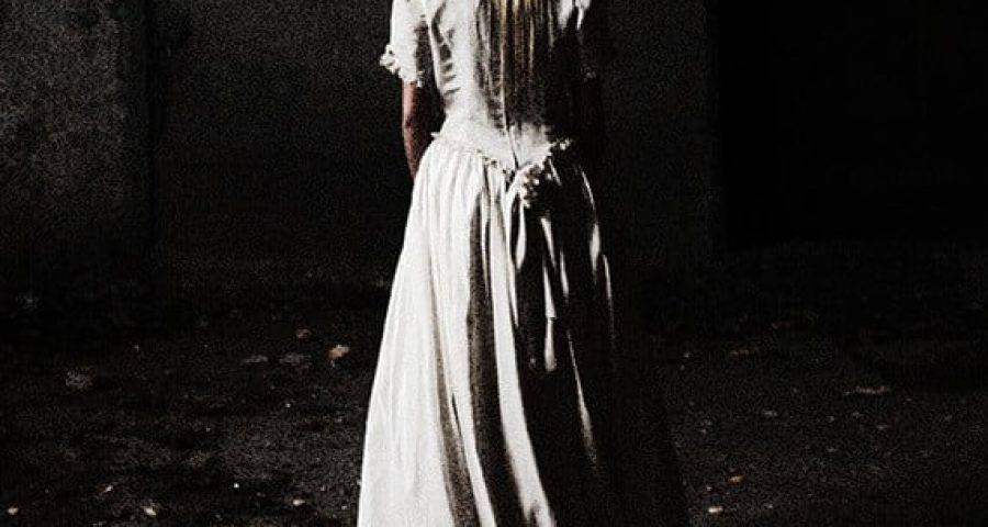 Connecting to the Dead? How Interested These Cities. woman in a dress facing away