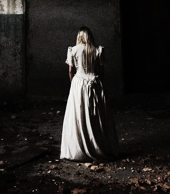 Connecting to the Dead? How Interested These Cities. woman in a dress facing away